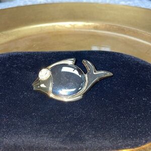 Olci fish Pendant gold, and silver tone.